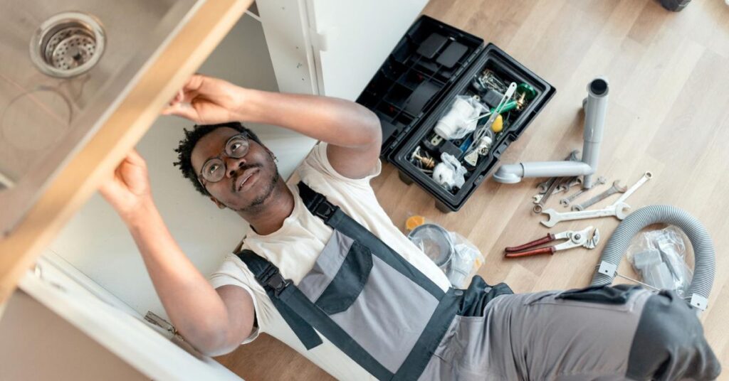 Plumber in Reading fixing a leaking pipe with professional tools and expertise